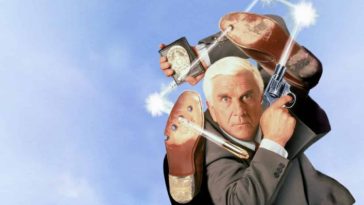 The Naked Gun Movie Wallpaper with Leslie nielsen in a grey suit holding a shooting gun and a police badge