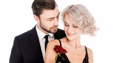 Happy couple of man and woman in black standing together