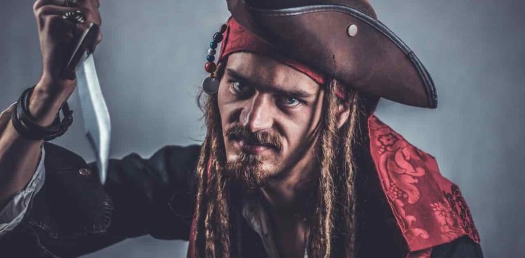 Pirate man with long hair holding a knife