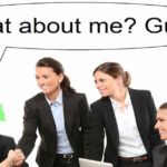 Office meeting men and women in suit a guy looks like clown with red nose and green hair