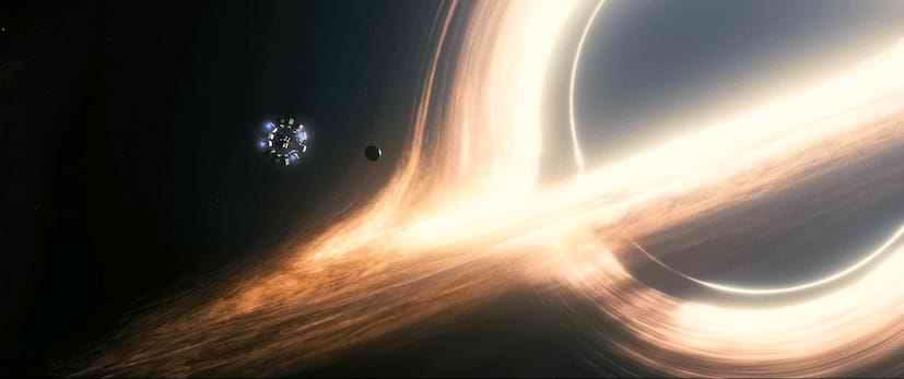 Interstellar movie spaceship flying close to a large black hole with a bright accretion disc around it in empty dark space