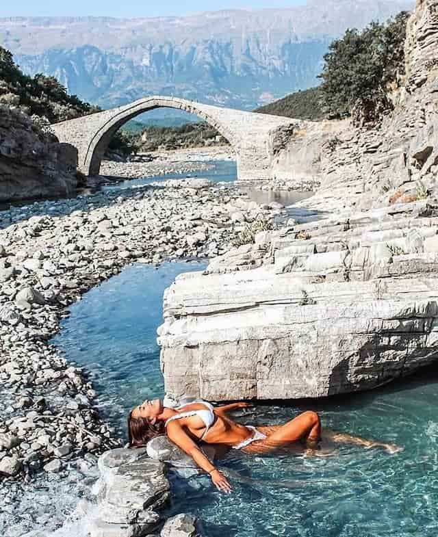 Woman in white bikini relaxing in thermal bath in benja