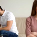 A man in white T-shirt and a woman in a pink T-shirt are mad at each other