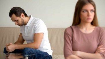 A man in white T-shirt and a woman in a pink T-shirt are mad at each other