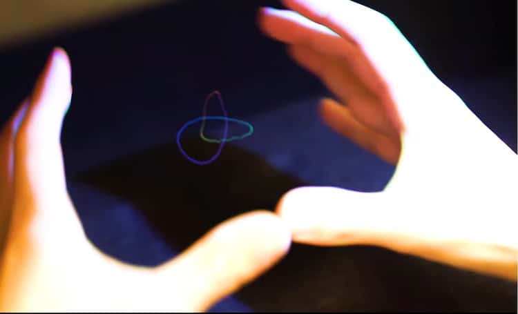 hands interacting with 3d hologram