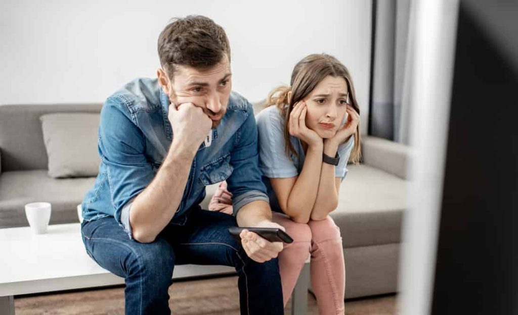 bored couple watching tv