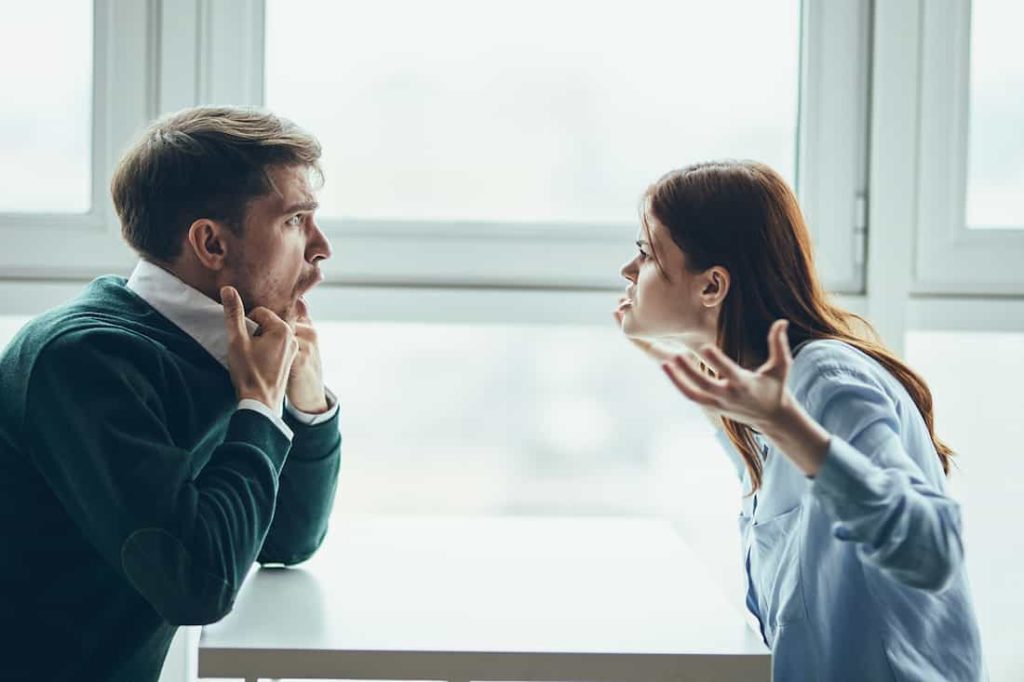 woman and man couple arguing while sitting