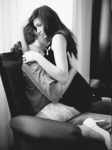 Woman having sex with a man on a chair black and white color