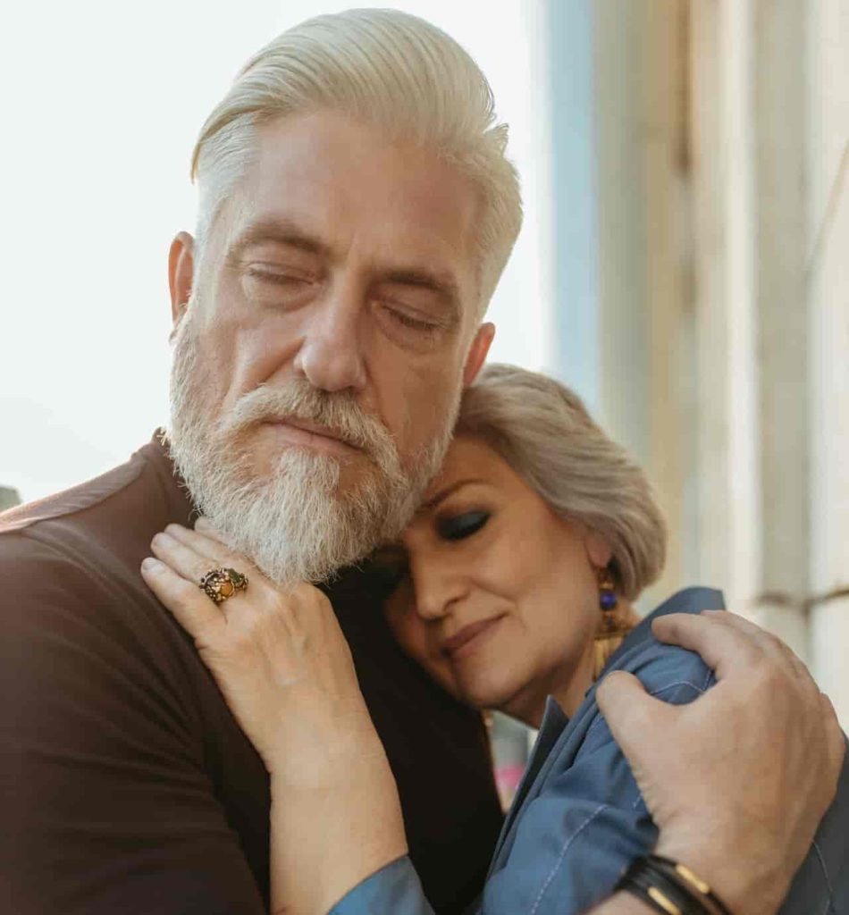 Elder couple hugging and feeling content