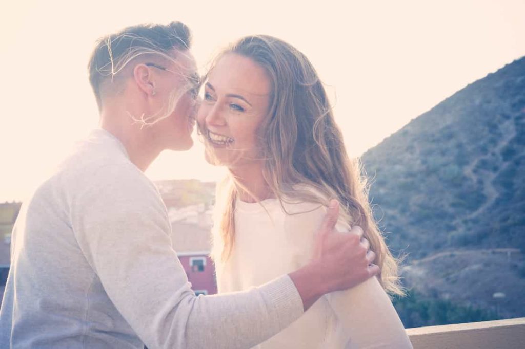 man makes blonde woman laugh